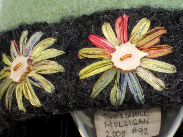 Detail of freehand ribbon embroidery with caribou antler buttons on knitted felt hat.
