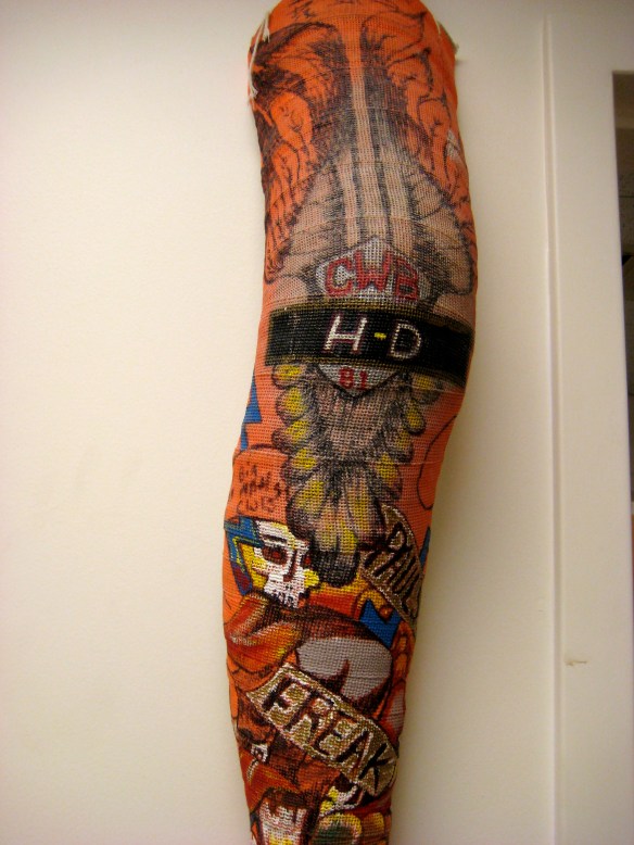 Intricate Harley-Davidson artwork "tattoo" on an orange fiberglass full-leg cast.