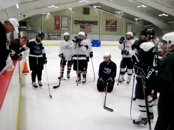 Coach Dick Dodds explains an on-ice hockey drill for the Learn-to-Play group at Campion Rink, NH