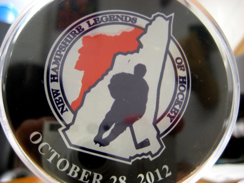 Hockey puck commemorating Coach Dick Dodds' recognition as a NH Legend of Hockey on October 28, 2012.