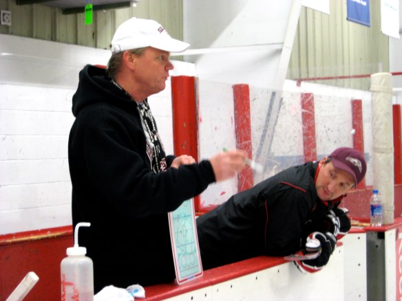 Coach Dodds explains an on-ice hockey drill for the adult Learn-to-Play group.