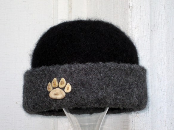 Felt Hat #12 of 2012: Paw print of caribou antler buttons on knitted felt hat, by fiber artist, Carrie Cahill Mulligan of Canaan, New Hampsire.