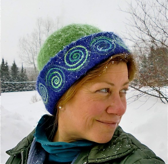 Vermont glass artist, Wendy Besett, caught wearing her favorite winter hat, a Carrie Cahill Mulligan original hand-knitted felt, with freehand spiral embroidery/