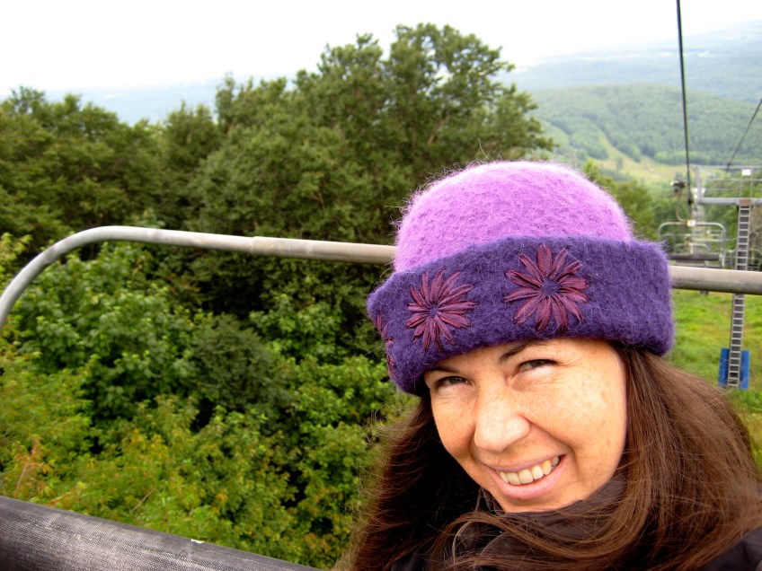 League of New Hampshire Craftsmen's fiber artist, Carrie Cahill Mulligan takes a ride on the chair lift at Mount Sunapee Resort in Newbury, NH during the Annual Craftsmen's Fair.